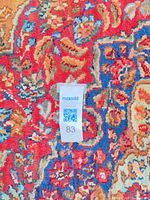 Close detail of pile and color palette showing maroon, blue, tan floral motif