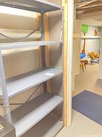 full view of one grey metal shelving unit showing five shelves