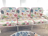 full view of three-seat metal porch sofa with cushions