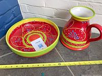 Bowl and pitcher together with measuring tape showing scale