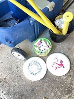 Blue two-seat wagon, chalk pail, discs, bats and balls