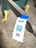 MaxSold tag on wooden handle indicating lot