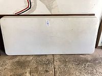 Full view of one folding table showing size and condition