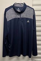 Full front view of Adidas navy/grey quarter-zip shirt on hanger
