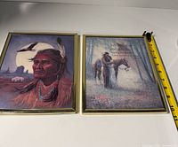 Both framed prints side by side with measuring tape