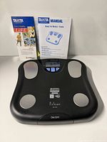 Top view of Tanita FitScan scale with manual and brochure