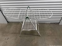Full view of drying rack unfolded showing wings and shelf