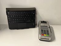 FD150 terminal beside Lenovo keyboard