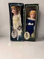 Front view of two boxed Geppeddo dolls showing outfits and box condition