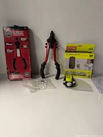 Doyle riveter in box and out, Ryobi laser level in package with accessories