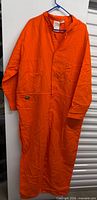 Full front view of orange coverall on hanger