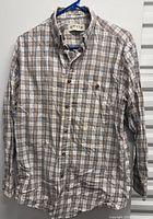 Front view of Orvis plaid shirt on hanger