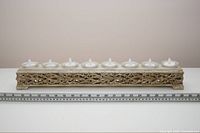 full view of candle holder with ruler showing width, LED tealights in place