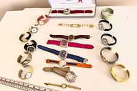 All nineteen watches arranged on table, showing variety of styles and colours