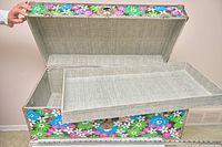 Trunk open showing removable interior tray and lined interior