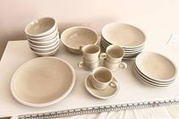 Full dinnerware grouping on tabletop showing counts and sizes