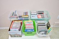 Five storage tubs filled with numerous CD cases and sleeves