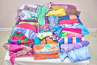 Full view of assorted multicolor scarves laid out on table