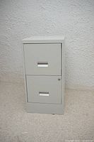 Front view of off-white two-drawer metal filing cabinet