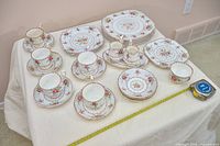 Overhead view of full 27-piece Royal Albert Petit Point dinnerware showing pattern and item counts