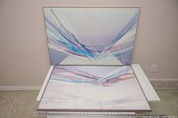 Both framed abstract prints standing and lying to show design and frame