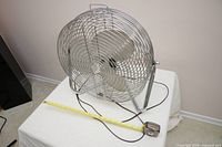 Fan side view on table with tape measure showing size
