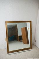 Entire mirror leaning against wall