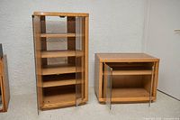 Tall and short matching light oak veneer cabinets with glass doors