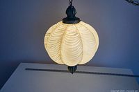 Pendant light illuminated, showing acrylic shade texture