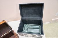 Open silver-blue inlaid chest showing interior and plastic tray