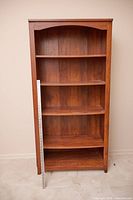 Front view of the bookcase showing shelves and scale