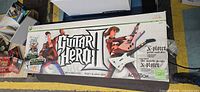 Front of Guitar Hero II retail box showing artwork and contents list