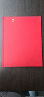 Front cover red cloth hardcover with embossed Montreal Olympic title
