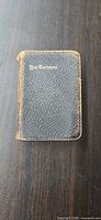 Front view of pocket New Testament showing cover texture and gilt title
