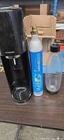 Full view of SodaStream machine, CO2 cylinder, and bottle