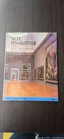 Front cover of "The Alte Pinakothek" book showing title and museum gallery image