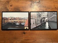 Both framed photos side by side on wood surface