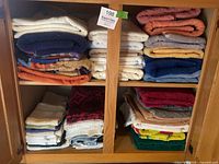 Cabinet showing multiple stacks of bath, hand and face towels