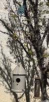Ceramic bird house, metal feeder, sun hook hanging on tree