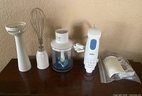 Full set showing motor, immersion shaft, whisk, chopper, bracket