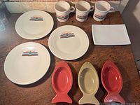 Overhead view shows 3 diner plates, 3 mugs, 3 fish trays, 1 rectangular tray