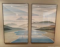 Both framed prints side by side on wall