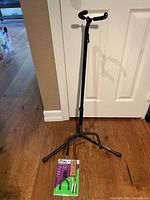Overall view of guitar stand fully extended and boxed ukulele/mandolin hanger on floor