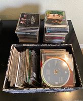 CD stacks and bin displaying quantity, case types, and floral pattern on bin