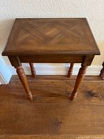 Top view of rectangular wood side table showing parquet inlay and overall condition