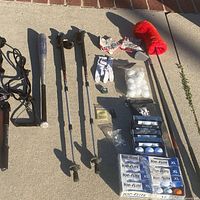All items laid out: golf clubs, bat, poles, pump, balls, gloves, tees, pin and reservoir visible