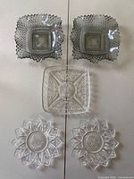 Grouped top-down view of all five clear pressed glass pieces