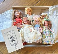 Box showing six porcelain dolls and Storybook Dolls leaflet