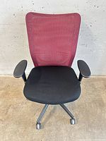 Front view of chair showing mesh back and upholstered seat