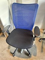 Full view of chair showing mesh back, seat, armrests and caster base